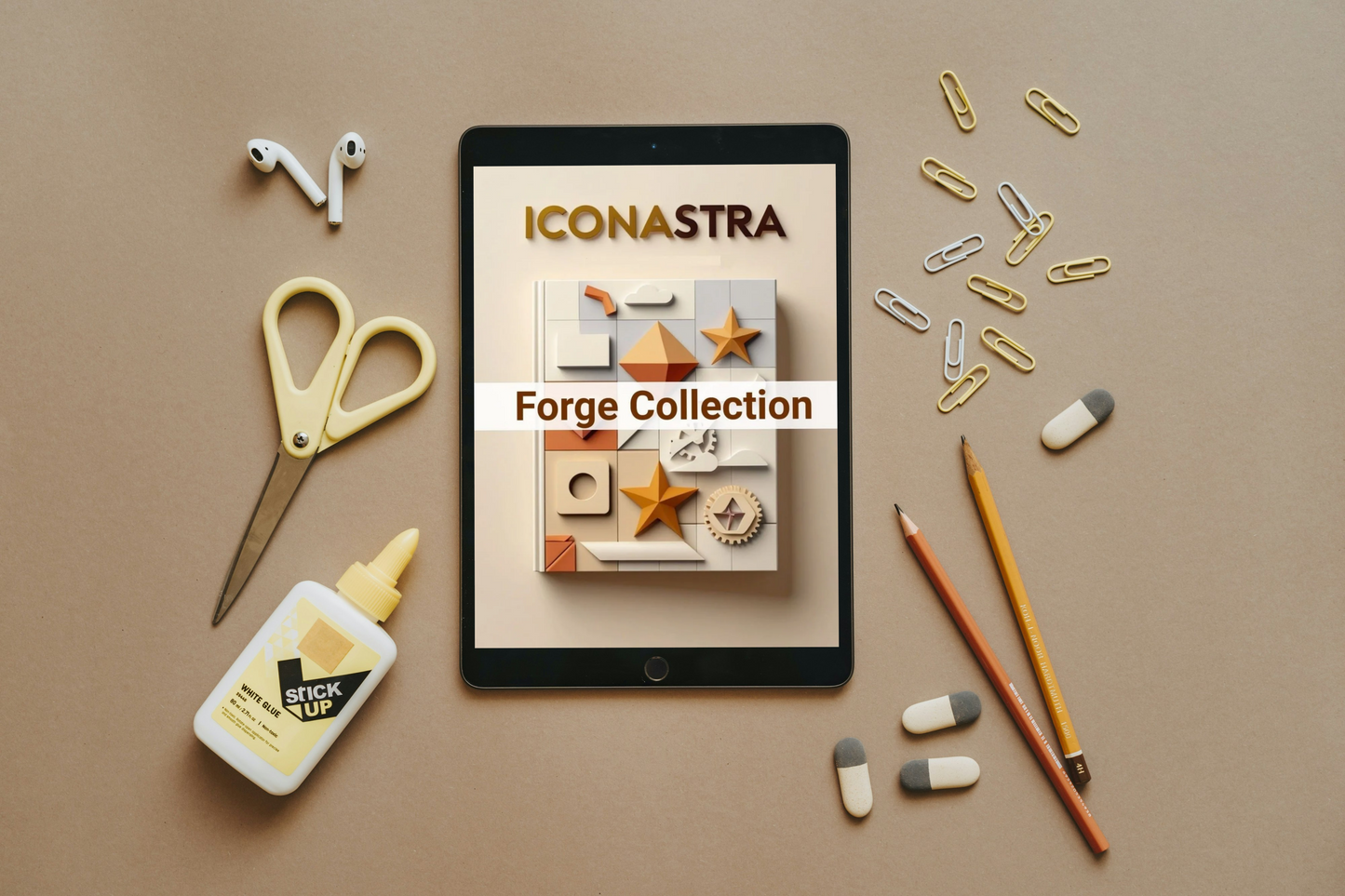 Tablet displaying 'Iconastra Forge Collection' on a brown surface with stationery items.