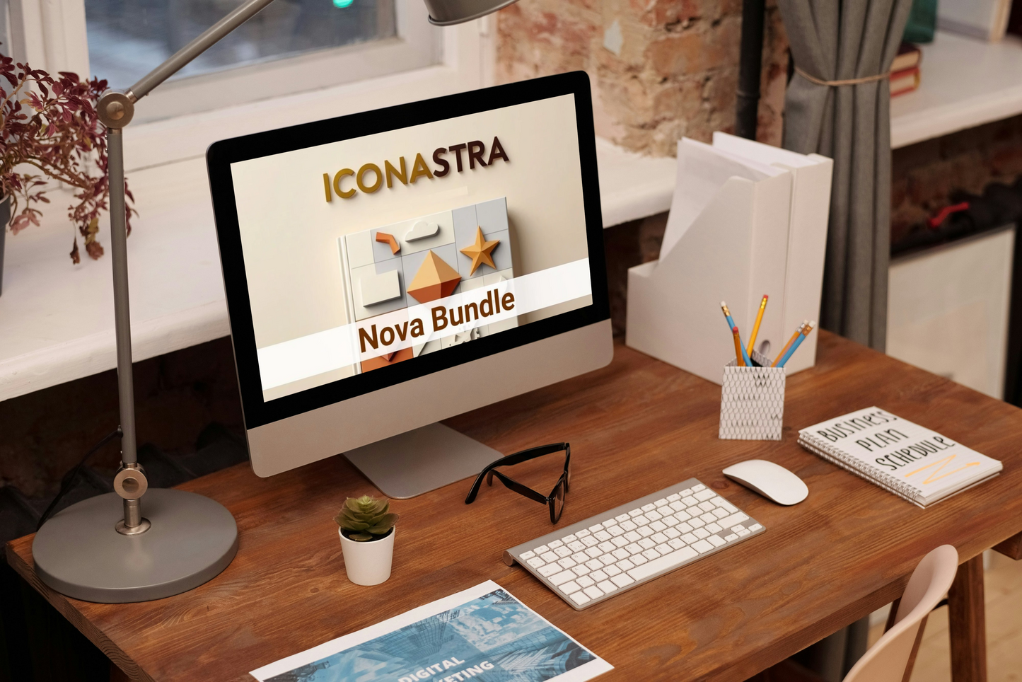 Computer monitor on a desk with 'Iconastra' branding displayed, surrounded by office supplies.